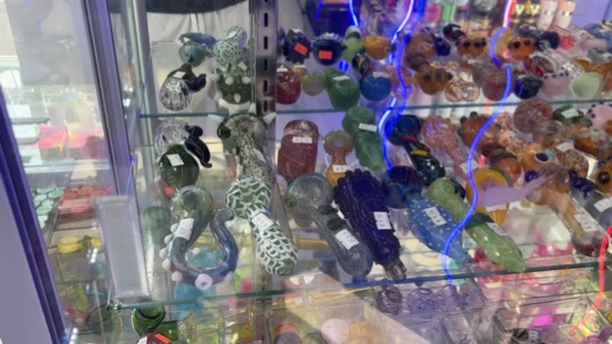 Glass pipe collection under neon lighting