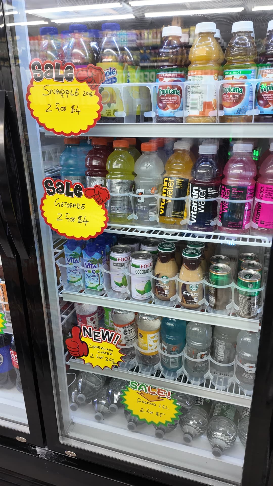 Cooler of Snapple, Gatorade, juices and sparkling water with sale signs